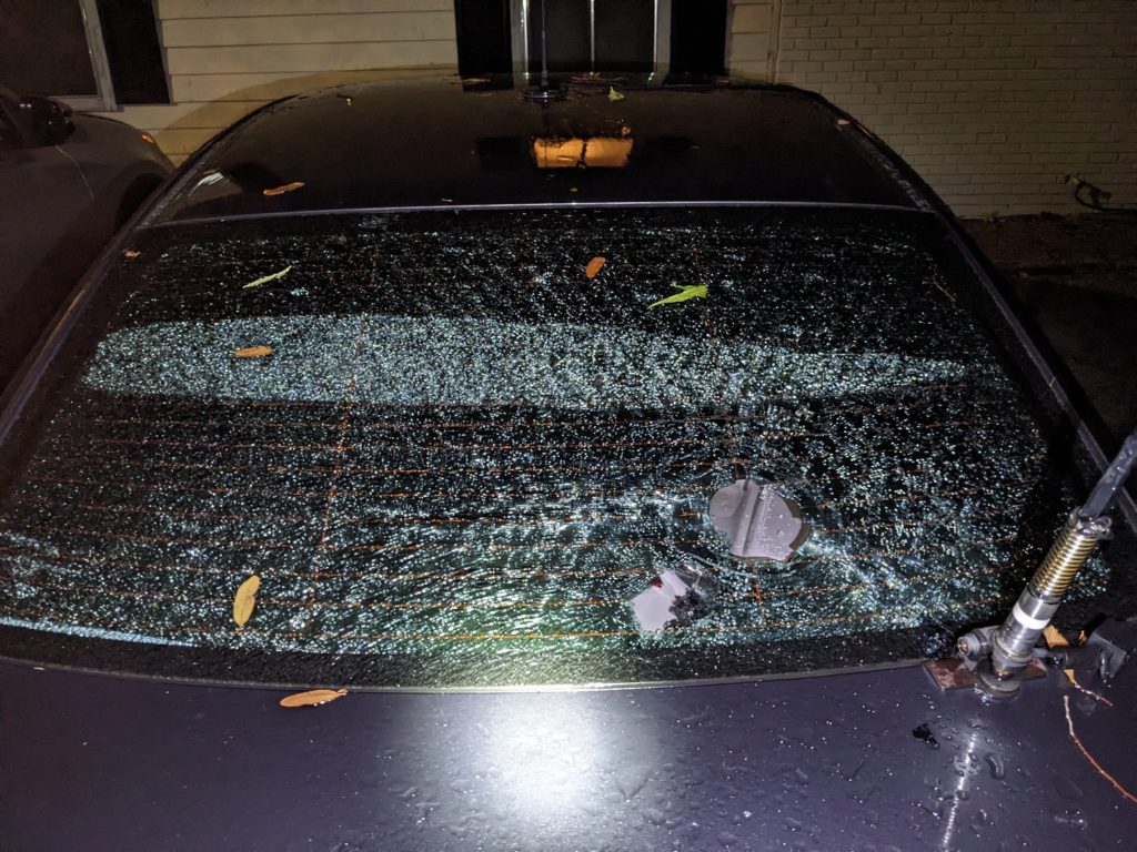 Fractured back window of my car with 3 hailstone holes
